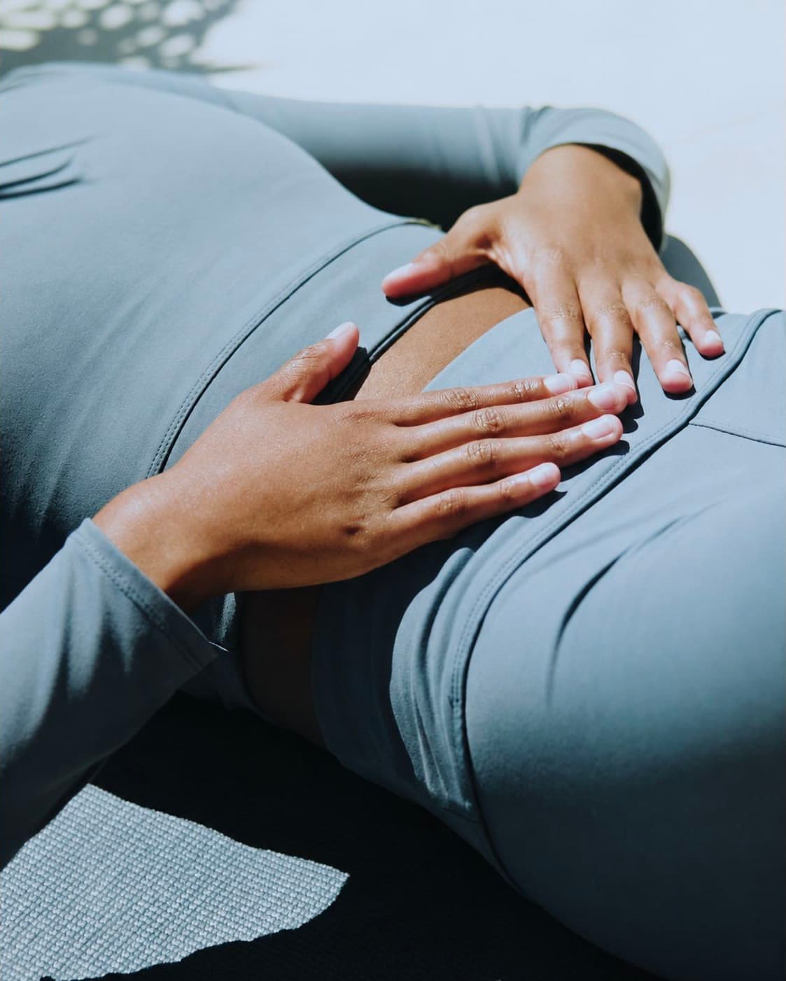 Person resting their hands on their abdomen