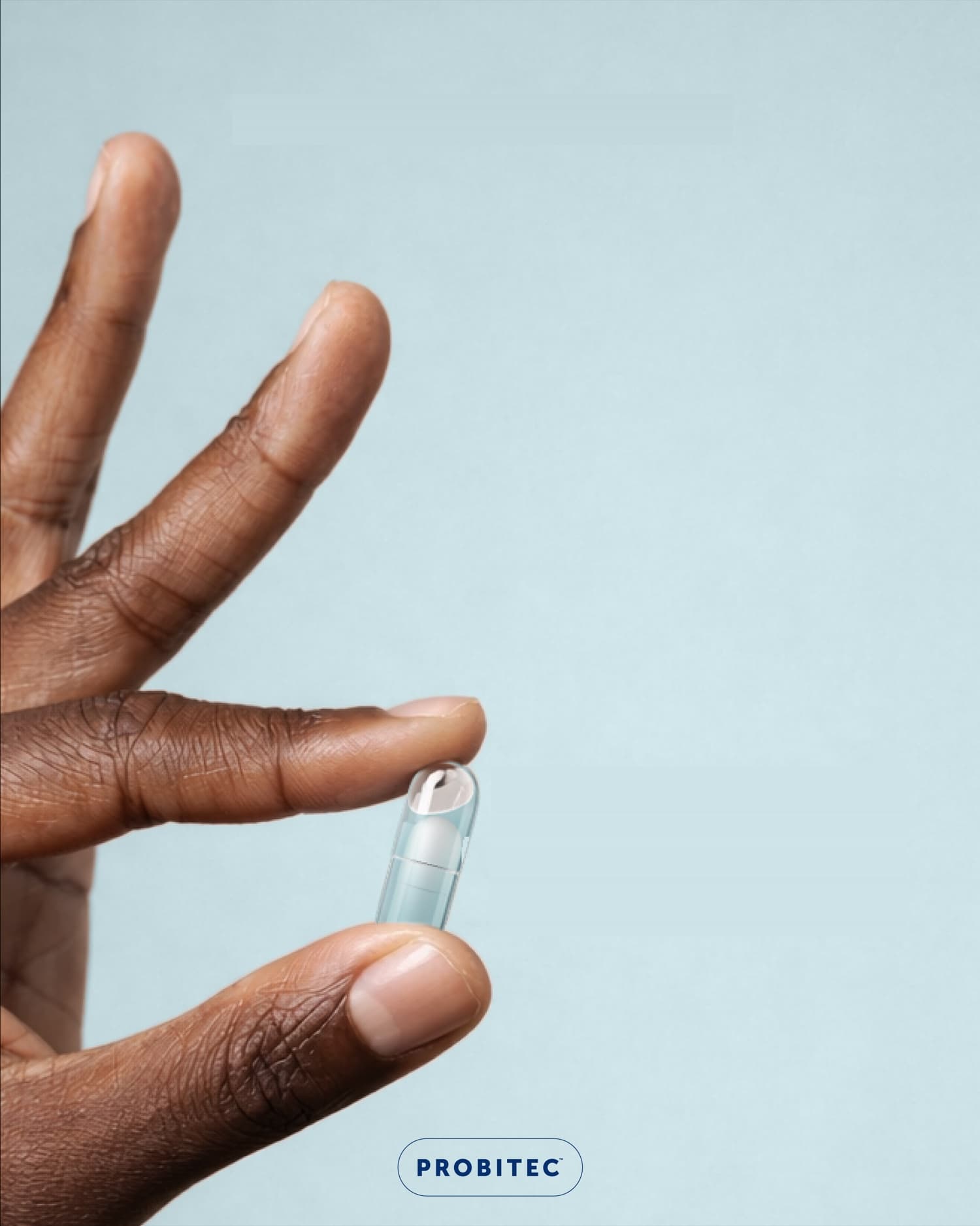 Hand holding a Probitec DuoCap capsule